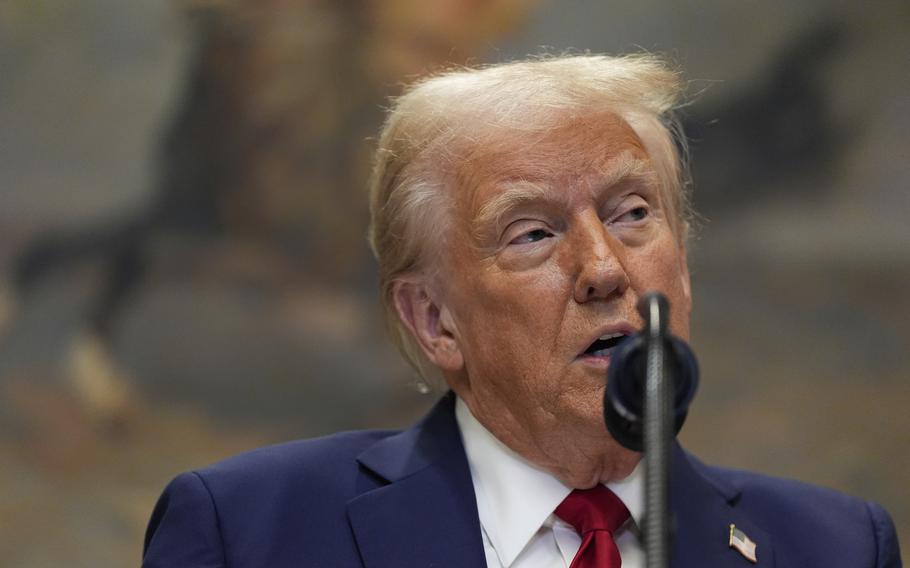 A close-up of President Trump’s face with a microphone in front of him covering part of his chin.