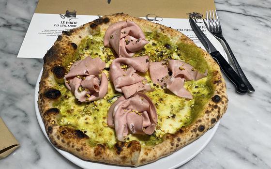 The pistachio and mortadella pizza at Peperino Pizza and Grill in Pordenone, Italy, Nov. 18, 2024. It features a Sicilian pistachio sauce, mortadella, smoked provola cheese and chopped pistachios topped with olive oil.