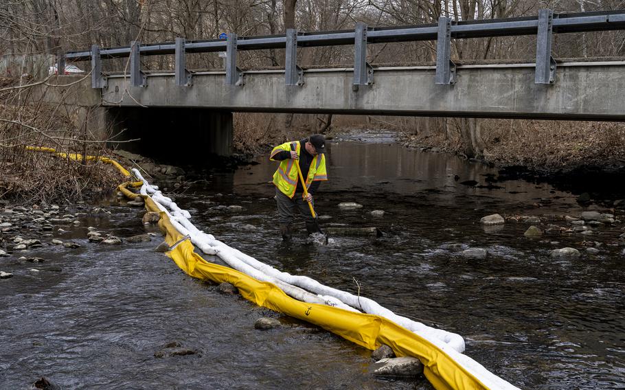 Ron Fodo, Ohio EPA Emergency Response, looks for signs of fish and also agitates the water in Leslie Run creek to check for chemicals that have settled at the bottom following the train derailment prompting health concerns on Feb. 20, 2023, in East Palestine, Ohio. 