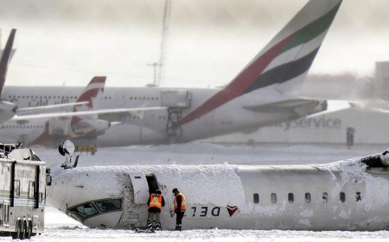 A Delta Air Lines plane lies upside down at Toronto Pearson Airport on Tuesday, Feb. 18, 2025. (Chris Young/The Canadian Press via AP)