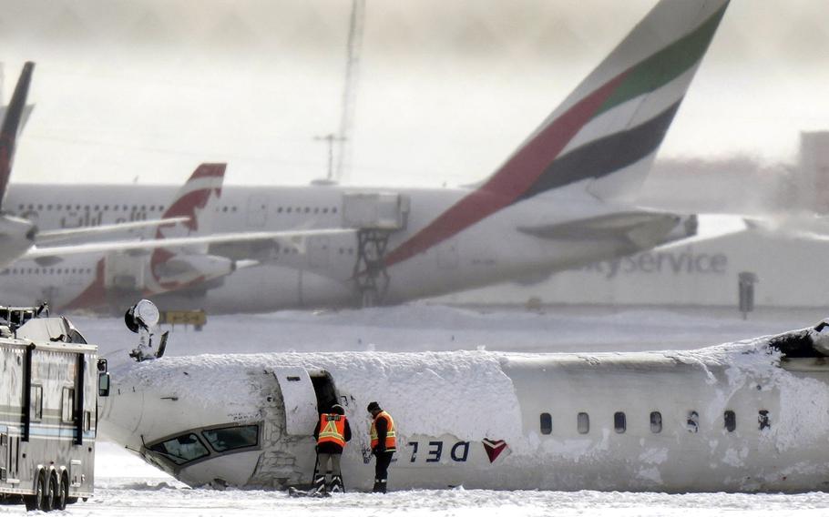 A Delta Air Lines plane lies upside down