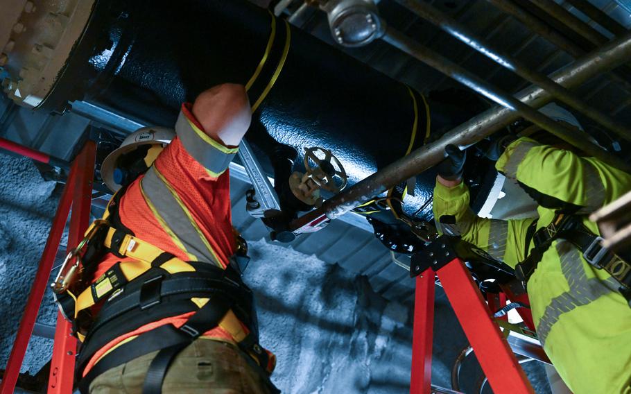 Members in support of Joint Task Force-Red Hill (JTF-RH) open a low point drain to enable the removal of residual fuel from the Red Hill Bulk Fuel Storage Facility Jan. 16, 2024, in Halawa, Hawaii. 