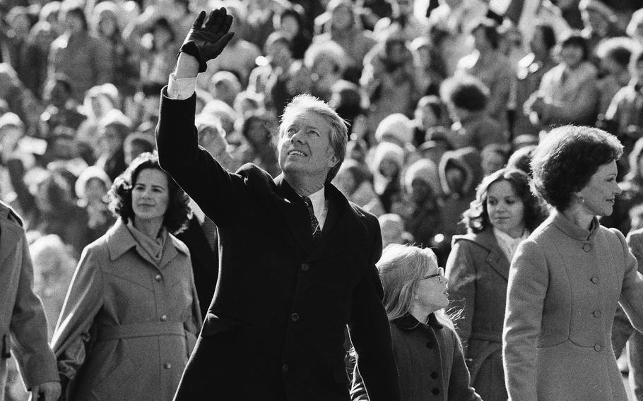 Jimmy Carter waves and acknowledges the cheers.