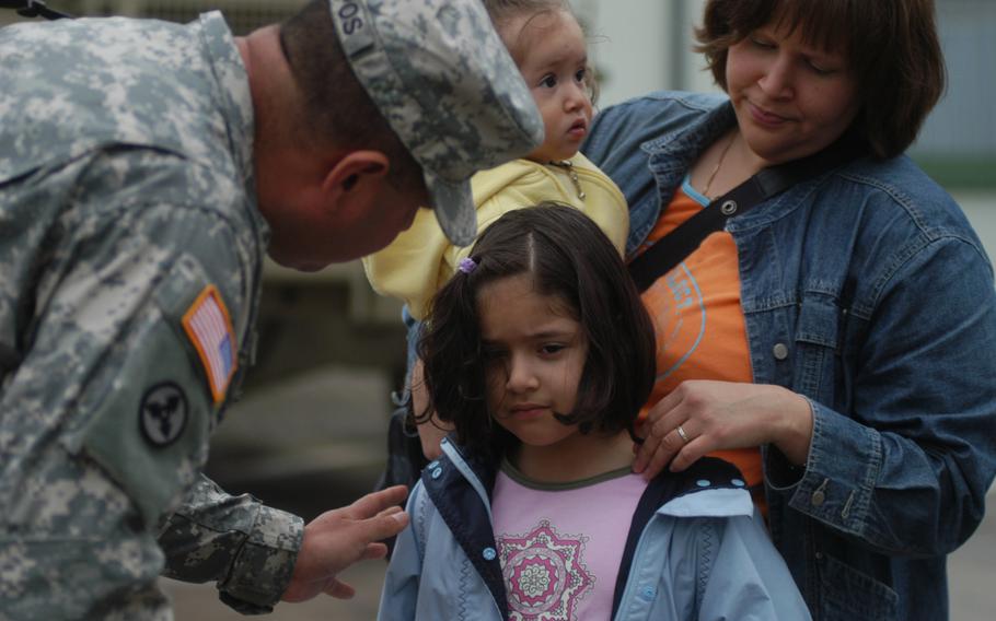 Staff Sgt. Rogelio Campos consoles his 6-year-old daughter, Marisol, before boarding a bus for the first leg of his journey to Iraq. Campos’ wife, Tania, held 15-month-old daughter Celina, who, unlike Marisol, didn’t have as clear an understanding of what was going on. Marisol, however, has already waited through one deployment for her father’s return. “She remembers the first time,” Mrs. Campos said. “Now she understands.”