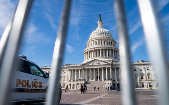 A Police Vehicle Is Parked Outside Of The U.S. Capitol As People Stroll ...