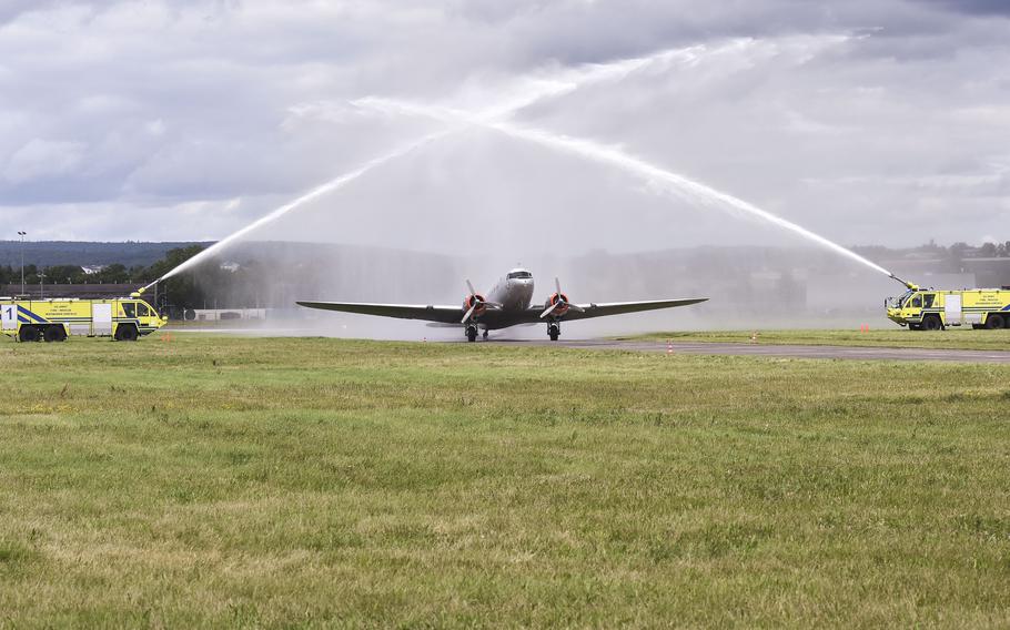 A Douglas C-47 Skytrain taxis underneath a water cannon salute during the Berlin Airlift 75th anniversary commemoration June 16, 2024, in Wiesbaden, Germany.