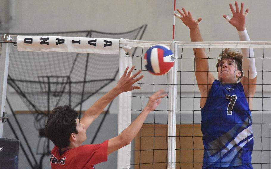 Aviano’s Xavier Fox pushes the ball towards the outstretched hands of Rota’s Christian Weaver on Saturday, Oct. 14, 2023, in the Saints’ four-set victory.