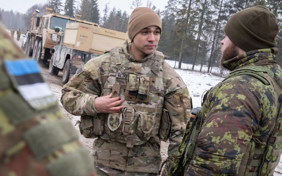 U.S. Army Maj. Adrian Betancourt talks to Estonian troops.