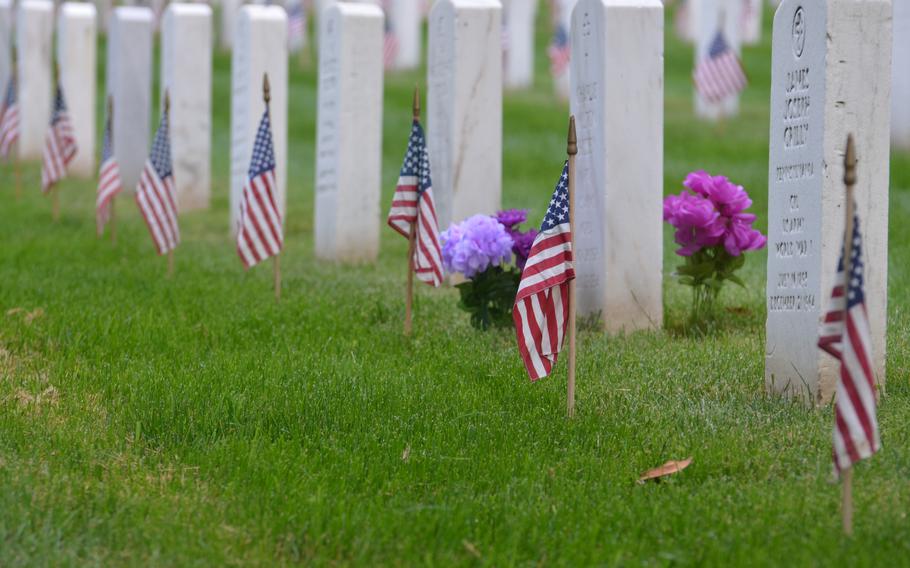 Members of the 3rd Infantry Regiment, also known as The Old Guard, place flags at the graves of those buried at Arlington National Cemetery for “Flags In” on Thursday, May 23, 2024, to honor fallen service members for Memorial Day. The annual event takes four hours for nearly 1,500 soldiers, including about 100 joint service members, according to Arlington National Cemetery.  