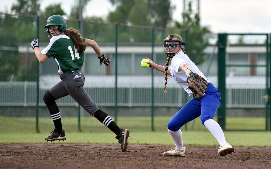 Rota shortstop Taylor Zimmerman throws to first base after Naple's Madisun Myers heads to third during the Division II/III DODEA European softball championship game on May 24, 2024, at Kaiserslautern High School in Kaiserslautern, Germany.