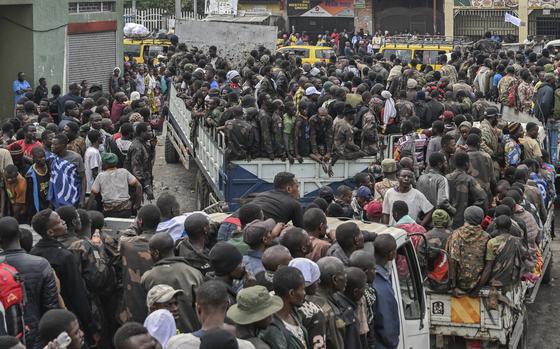 A mass of people packed into trucks and lorries.