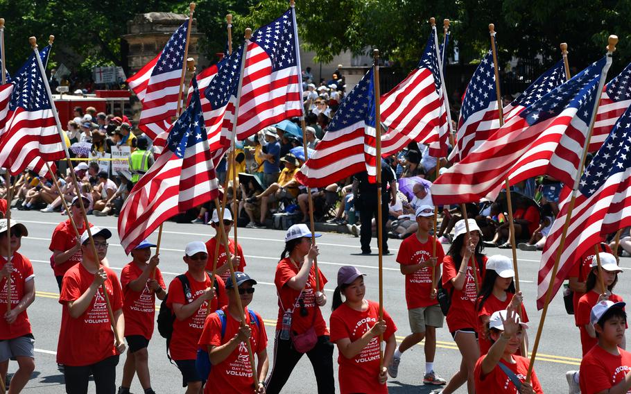 Members from volunteer organization Folds of Honor march while carrying America flags in the Washington, D.C. Independence Day parade on July 4, 2024.