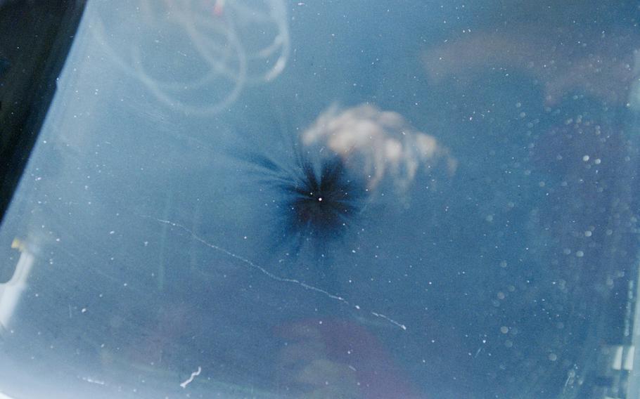 A black spot on a window of the International Space Station after it was hit by debris.