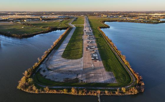 A former runway with cars parked on it juts out into Mountain Creek Lake.