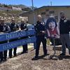 Police pose in front of an elementary school with a poster of a young girl.