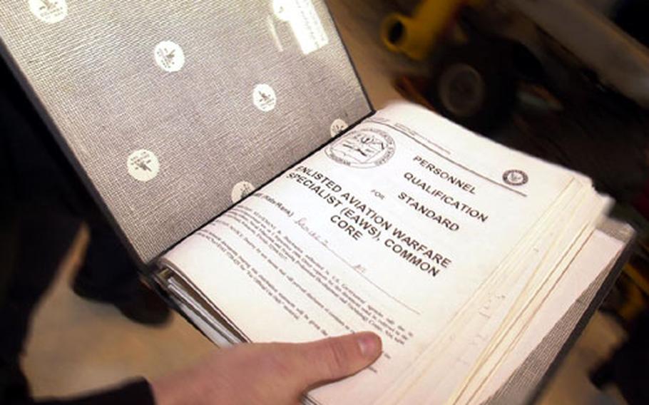 Sailors carry their Personnel Qualification Standards book with them at all times to get the signatures required for their warfare pins.