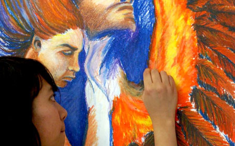 Aline Villaneuva, 16, from Aviano High School, Italy, works on her piece in the oil pastels workshop.