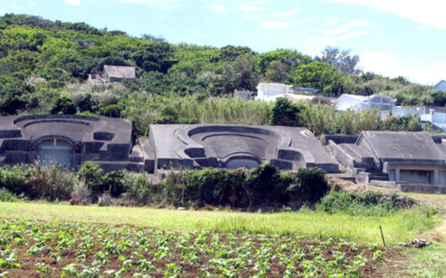 Okinawa turtle back tombs and the more modern "house" tombs dot a hillside in the Nagahama district of Yomitan. Adopted from China in the 16th century, Okinawans reinterpreted the meaning of the turtle shapes, believing the tombs represented a woman&#39;s womb.