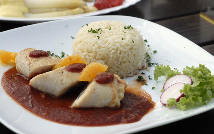 A chicken breast filled with ham and sage served with tomato sauce, rice and salad cost 13.40 euros at the Gasthaus Zum Engel in Wiesbaden, Germany.