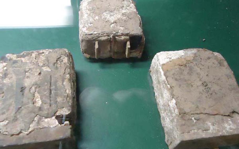 In a display case in one of the Tateyama Air-raid Shelter's empty rooms, lies the battered batteries that powered phones used to call for help after the atomic bomb was dropped on Nagasaki by the U.S. on Aug. 9, 1945. The artifacts were unearthed many years later. The shelter is one of Nagasaki's most historically significant, yet largely forgotten sites, and protected important Japanese officials as the atomic bomb devastated the city around them that fateful day. It was from this shelter that initial relief efforts were coordinated and updates were sent to Tokyo. 