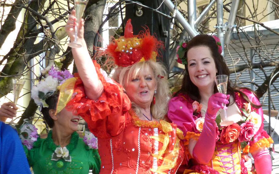 Market women toast the crowd on the Viktualienmarkt in Munich, Germany, on Fat Tuesday in 2010. The women were preparing to take part in the Dance of the Market Women, one of Carnival season's unique traditions in Munich.