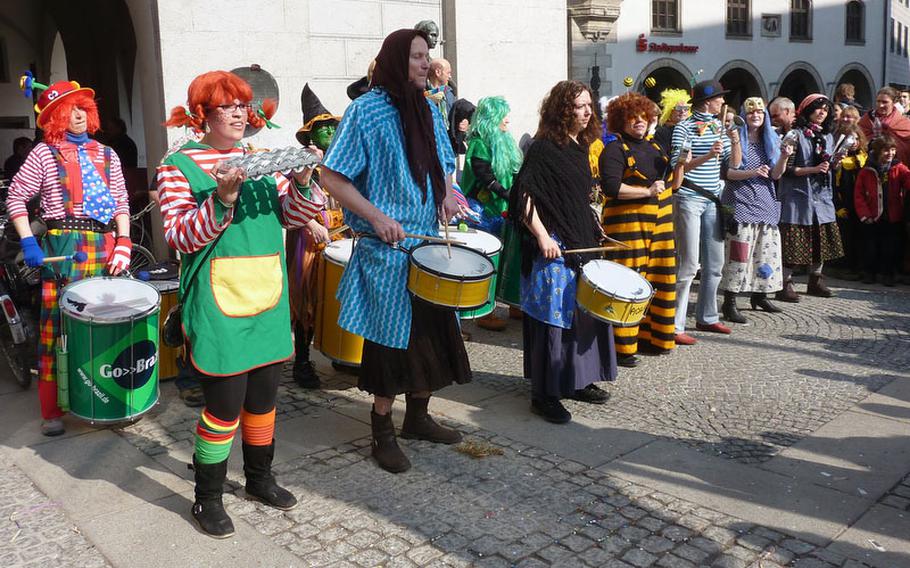 A costumed percussion band entertains spectators during 2010 Fasching celebrations in Munich.