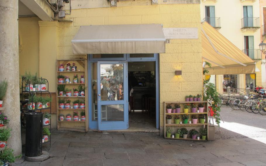 The unassuming entrance to the Angolo Palladio restaurant in Vicenza, Italy, is flanked by cans of herbs and spices.