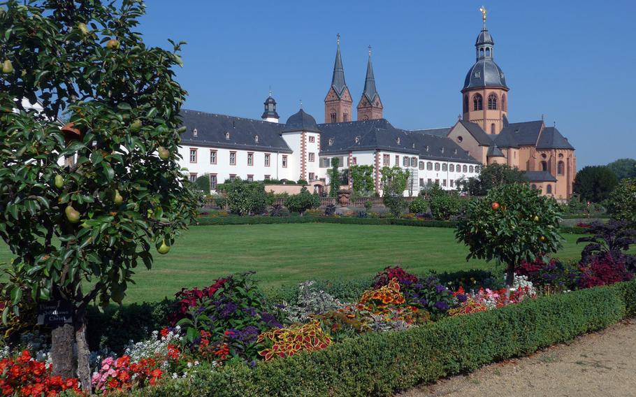 The former Benedictine abbey and the Carolingian Einhard Basilica in Seligenstadt, Germany, as seen from the cloister gardens. The abbey was secularized in 1803. Parts of the church date back to the ninth century.