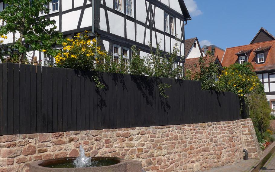 The Rote Brunnen or Red Fountain in Seligenstadt, with one of the German town's many half-timbered houses in the background. There has long been a fountain on this spot, but this version dates from 1965.