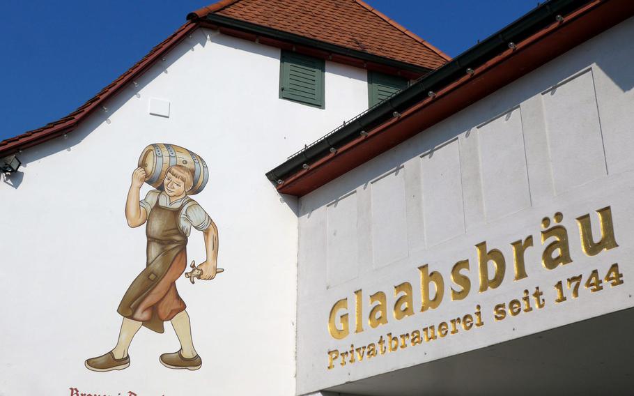 A brewer carries a keg of beer in a painting that adorns the Glaabsbraeu brewery in Seligenstadt, Germany. The private brewery has been making beer here since 1744.