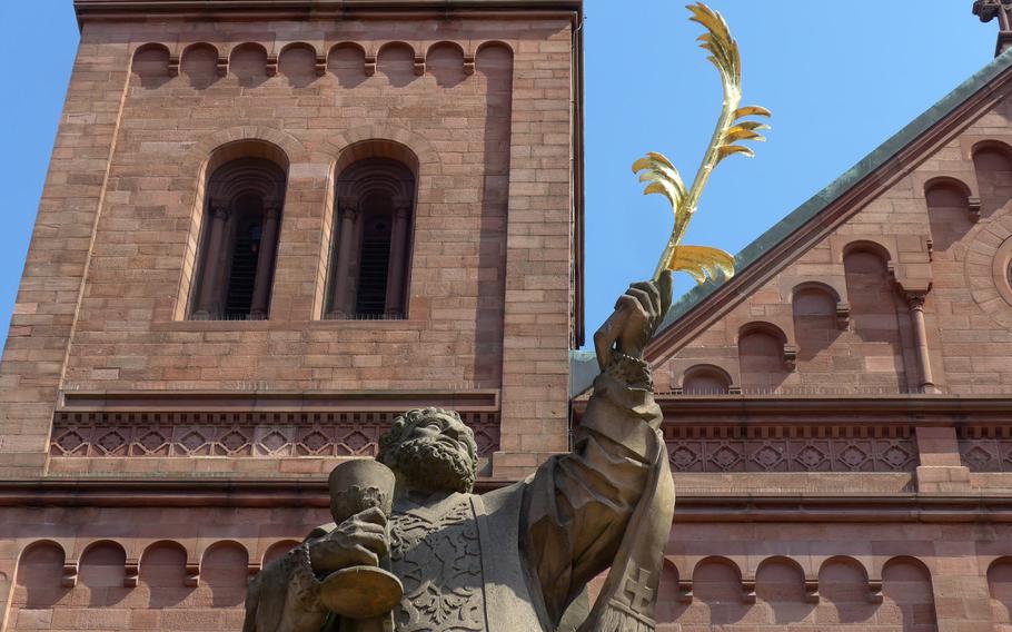 A statue of Saint Marcellinus, a martyr, stands in front of the Carolingian Einhard basilica in Seligenstadt, Germany. The oldest part of the church dates back to the ninth century.