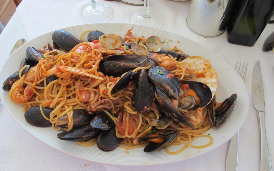 Seafood spaghetti at da Angelo, on the outskirts of Vicenza, Italy, costs 15 euros and provides more than one serving. Seafood is a speciality of the restaurant but it also offers 90  varieties of pizza.