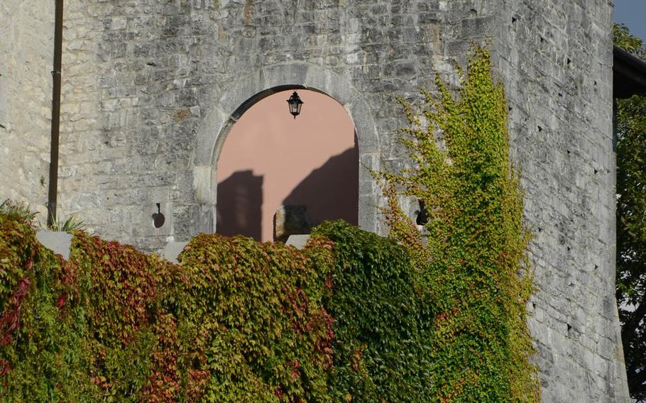 Vegetation covers a wall and tower leading to an entrance to the Sanctuary of Castelmonte, the Blessed Virgin Mary, which is located about 16 miles from Udine, Italy.