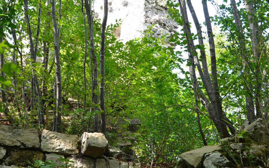 The rubble from the Attimis Lower castle is partially obscured by vegetation.