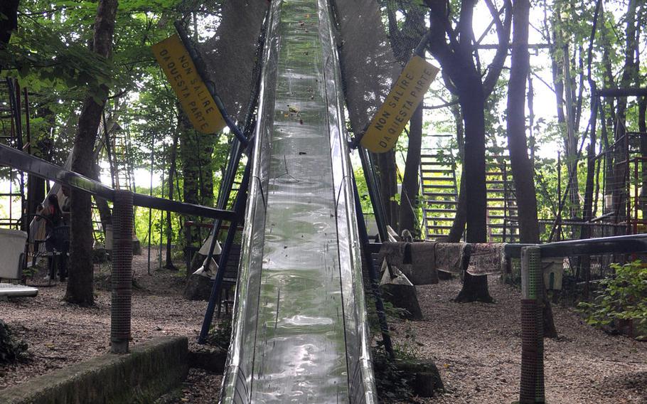 Those wanting to go down this long slide in the play park at Osteria ai Pioppi near  Nervesa Della Battaglia, Italy, have to ascend a ladder into the trees. It's a bit narrow for many adults.