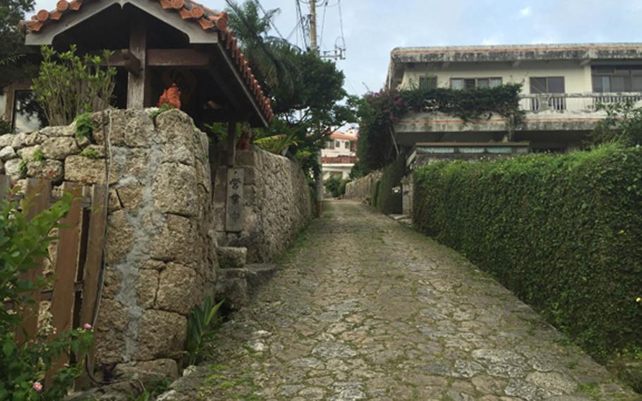 Sui Dunchi's entrance sits on the left in this photo, nestled on the Kinjo cobbled path. The road was built by Okinawan King Sho Shin during the golden age of the Ryukyu kingdom in the 16th century and connected nearby Shuri Castle with Naha's port.