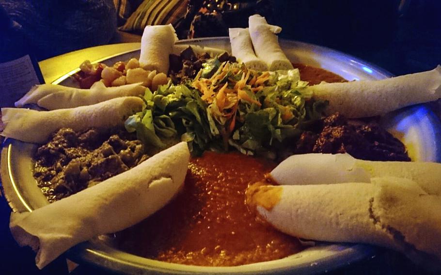 The house specialty at Im Herzen Afrikas, meant to be eaten communally, features four stews, two sauces, a salad and plenty of ''injera,'' an Eritrean flatbread. The injera also serves as silverware and is meant to be used to scoop up the stews and sauces.