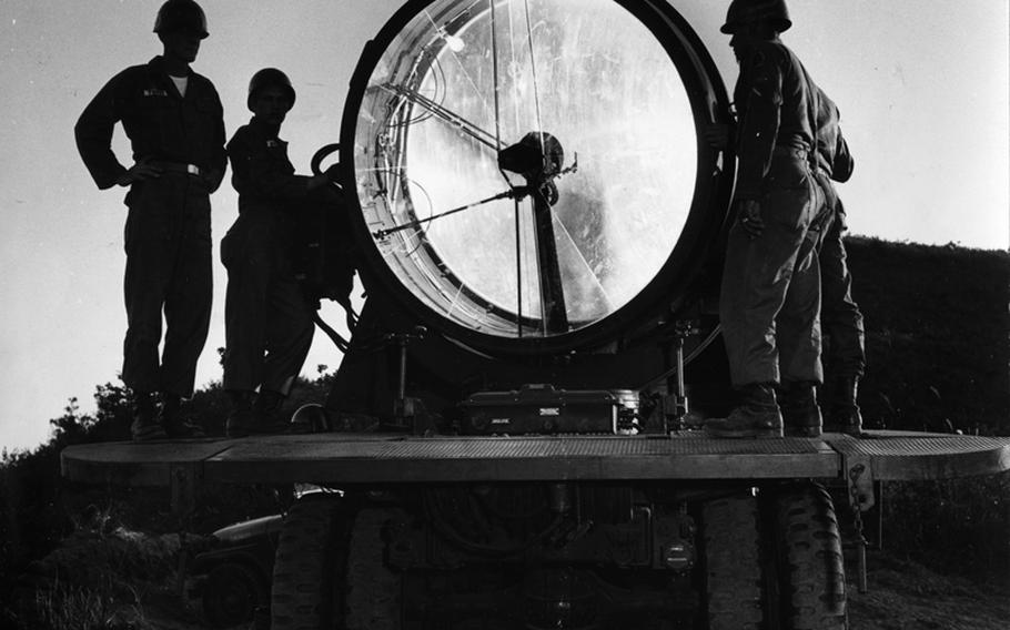 A searchlight mounted on a 2½-ton truck is tested near Camp Casey, South Korea, in 1957.