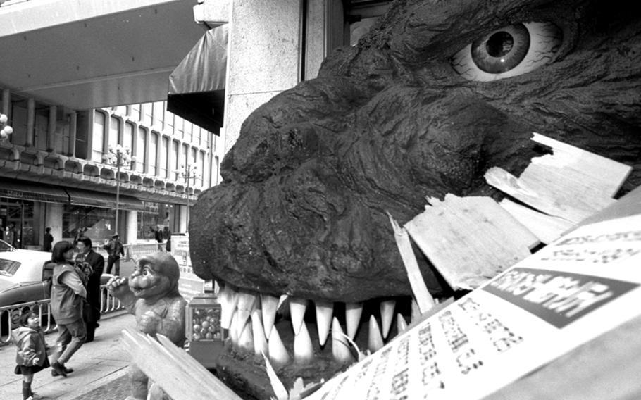 A model of Godzilla's head greets passers-by outside a Tokyo store during a promotional campaign for the latest in a long series of movies featuring the fearsome reptile.
