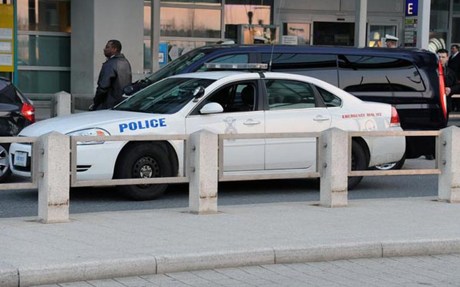 A U.S. Air Force security police car stands in front of the Frankfurt international airport's Terminal 2, where a gunman shot and killed two American airmen and wounded two others.