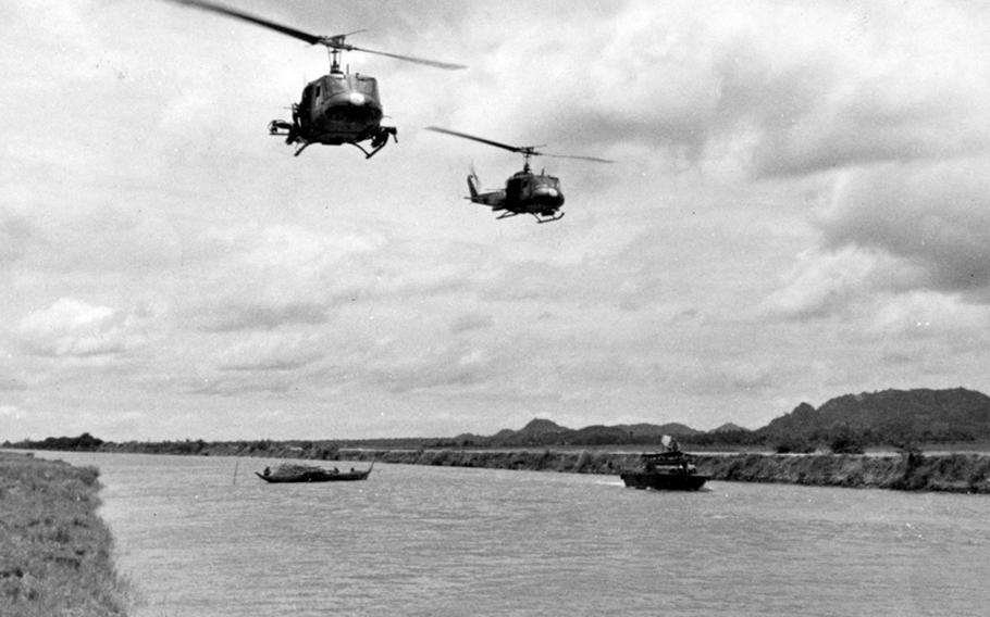 Choppers fly over a canal near the Cambodian border, looking for signs of the enemy.