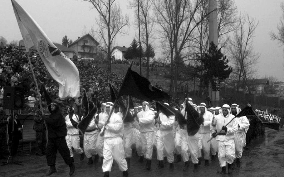 Members of the Bosnian army's 3rd Muslim Brigade march through Tuzla's stadium during Independence Day celebrations on March 1, 1996.
