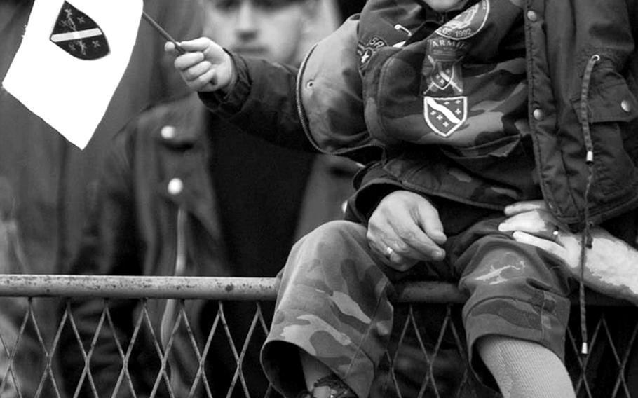 A youngster waves a Bosnian flag at an Independence Day celebration held at Tuzla's stadium on March 1, 1996.