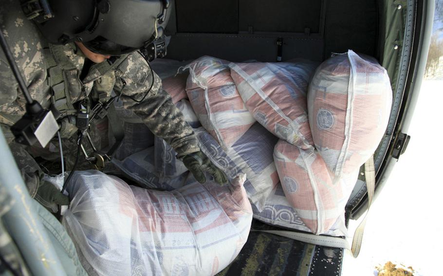 Spc. Errol Sahagun, of the 1st Battalion, 214th Aviation Regiment, 12th Combat Aviation Brigade, delivers supplies to snow-stranded residents of Montenegro during a humanitarian mission in February. Now the U.S. is offering a different kind of aid — supporting Montenegro’s bid to join NATO.