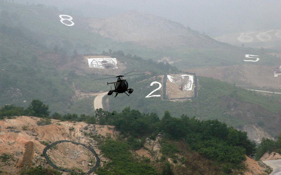 An attack helicopter approaches a target on June 22, 2012,  during a live-fire drill involving the militaries of the U.S. and South Korea. The hourlong exercise was staged in front of more than 4,000 spectators about 15 miles south of the Demilitarized Zone.