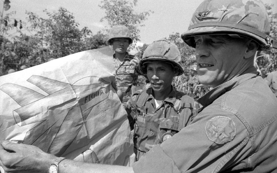 American and South Vietnamese officers display a captured Viet Cong drawing of a U.S. aircraft.