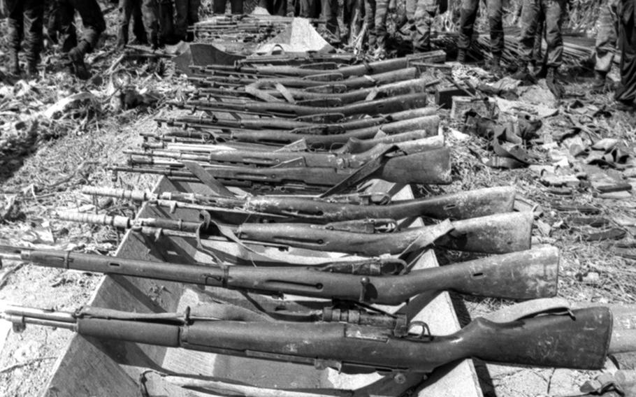 Weapons captured from Viet Cong troops during the battle are displayed.