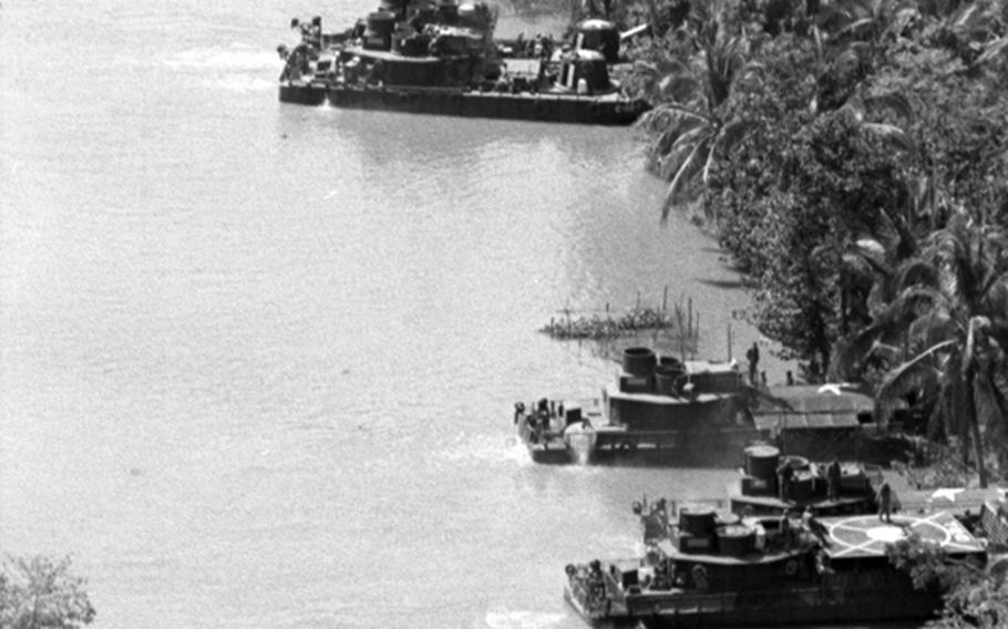 Boats are beached near where Americans from the 9th Infantry Division's 2nd Brigade Riverine Force and South Vietnamese from the 5th Vietnamese Marine Battalion battled the Viet Cong along the My Tho River, 65 miles southwest of Saigon.