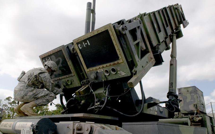 U.S. Army Pfc. Dean Werner, 1-1 Air Defense Artillery, Charley Battery Patriot missile operator, simulates unlocking the launcher caps during a field training exercise on Kadena Air Base, Japan, Oct. 26, 2011.