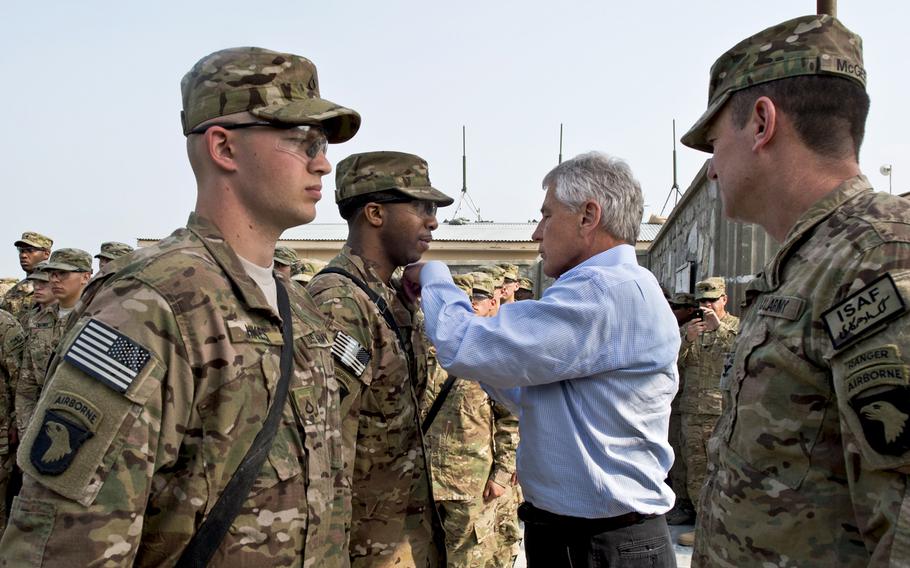 Secretary of Defense Chuck Hagel presents a purple heart to a soldier in Jalalabad, Afghanistan, March 9, 2013. Hagel has ordered a review of the new Distinguished Warfare Medal following complaints from veterans groups and lawmakers about its ranking above the Bronze Star and Purple Heart, a senior defense official said Tuesday.